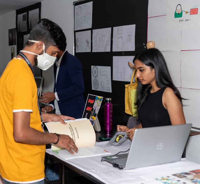 Faculty evaluating student’s work brand prototypes - Evaluation - Brand Prototypes with a Spin – Display and Jury by students of PGDFC