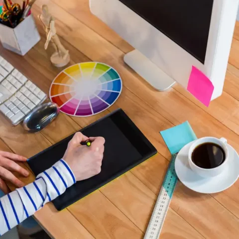Designer working with colour wheel and digitizer in the office